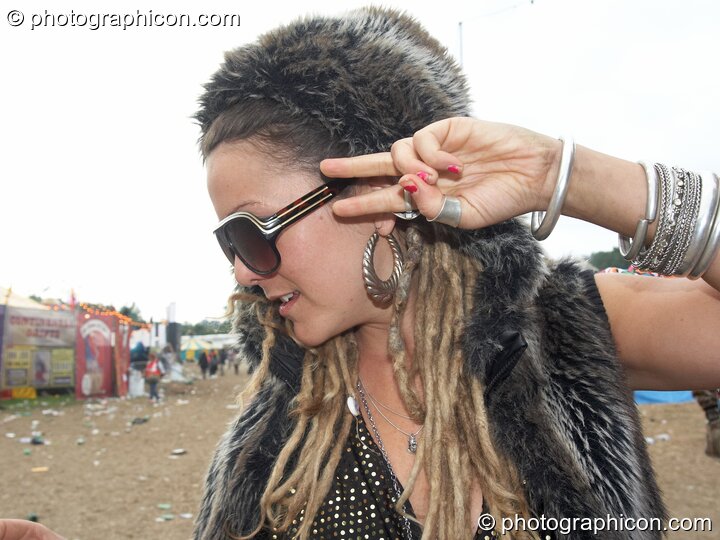 A woman salutes at Glastonbury Festival 2008. Pilton, Great Britain. © 2008 Photographicon