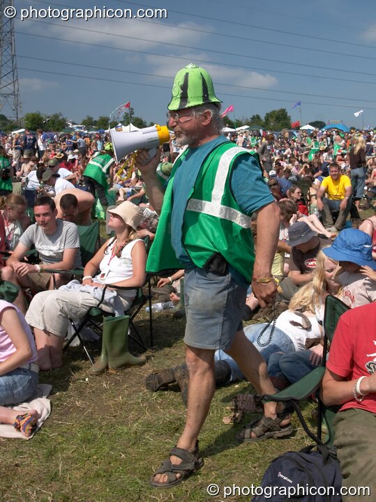 Green Police in action encouraging the public to pick up litter in the main arena at Glastonbury Festival 2005. Pilton, Great Britain. © 2005 Photographicon