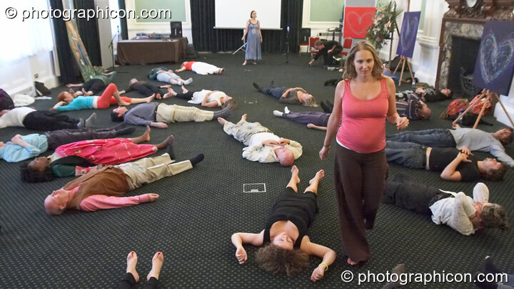 The participative audience lie in relaxation on the floor at London Festival of Tantra 2009. Great Britain. © 2009 Photographicon