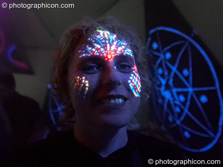 A woman with UV fluro face paint at Planet Bob's Offworld Festival 2007. Swindon, Great Britain. © 2007 Photographicon