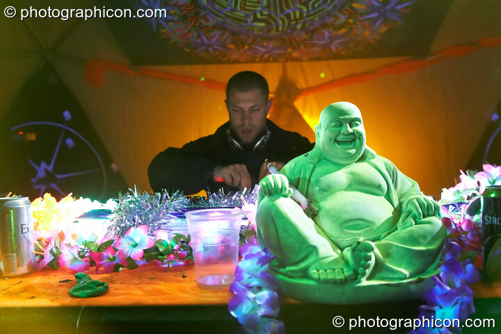 Moonquake (Nico Pianet - Hadra/Chrysalid, France/UK) DJs with a plastic Buddha on the Main Stage at Planet Bob's Offworld Festival 2007. Swindon, Great Britain. © 2007 Photographicon