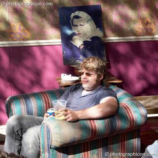 Man relaxing in an armchair in the tree house at the Secret Garden Party 2006. Huntingdon, Great Britain. © 2006 Photographicon
