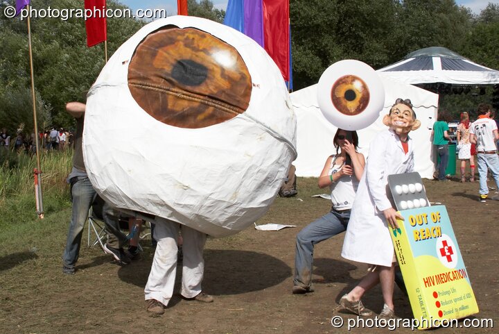 A campaigning group dressed in a giant eye draw attention to the politics of HIV medicine at the Secret Garden Party 2006. Huntingdon, Great Britain. © 2006 Photographicon