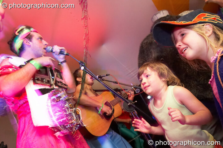 Two children dance while Django Spears perform on the Small World Stage at the Secret Garden Party 2007. Huntingdon, Great Britain. © 2007 Photographicon