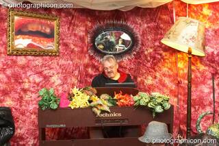 A man plays piano in a small fur-lined lounge tent at the Secret Garden Party 2007. Huntingdon, Great Britain. © 2007 Photographicon