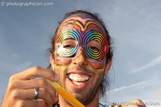 A man with a brightly coloured face at the Secret Garden Party 2007. Huntingdon, Great Britain. © 2007 Photographicon
