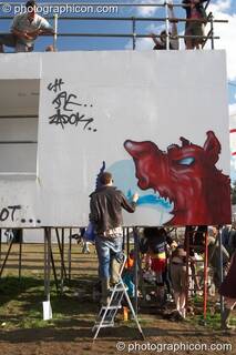 A graffiti artist paints The Tower at the Secret Garden Party 2007. Huntingdon, Great Britain. © 2007 Photographicon