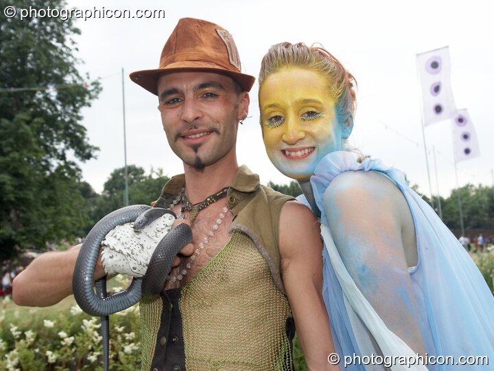 A wonly couple carrying a rubber snake at the Secret Garden Party 2008. Huntingdon, Great Britain. © 2008 Photographicon