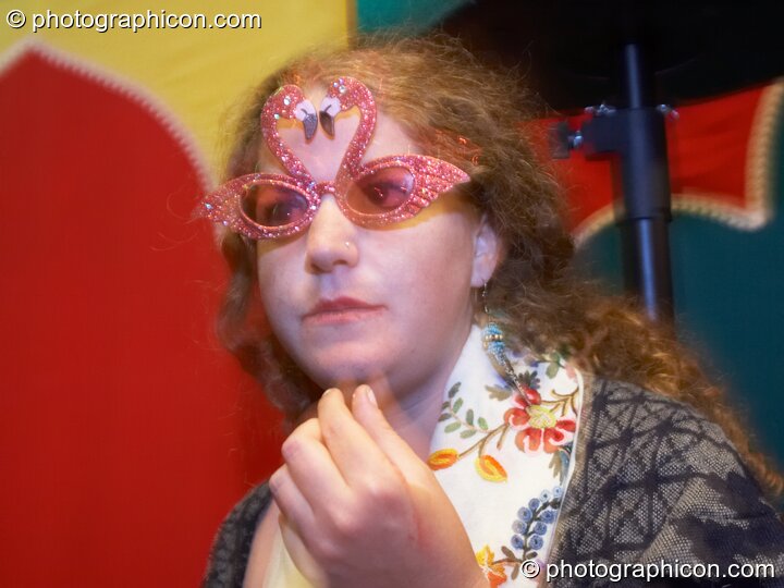 A woman wearing wonky glasses dances in the Lizard tent at the Secret Garden Party 2010. Huntingdon, Great Britain. © 2010 Photographicon