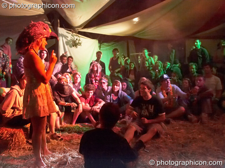 A woman wearing a wonky bird hat presides over a tag wrestling game in the Artful Badgers tent at the Secret Garden Party 2010. Huntingdon, Great Britain. © 2010 Photographicon