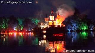 An archer's flaming arrow speeds towards the Galleon ship on the lake at the Secret Garden Party 2008. Huntingdon, Great Britain. © 2008 Photographicon