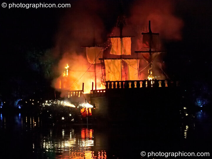 Fireworks erupt aboard the burning Galleon ship on the lake at the Secret Garden Party 2008. Huntingdon, Great Britain. © 2008 Photographicon