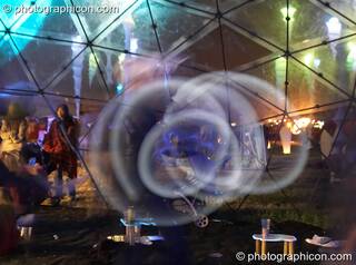 Alex Lee works his glow poi in the idSpiral dome at Sunrise Celebration 2006. Yeovil, Great Britain. © 2006 Photographicon