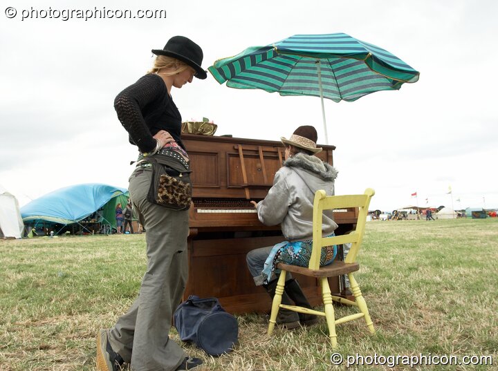 Punters play piano in a field at Sunrise Celebration 2006. Yeovil, Great Britain. © 2006 Photographicon
