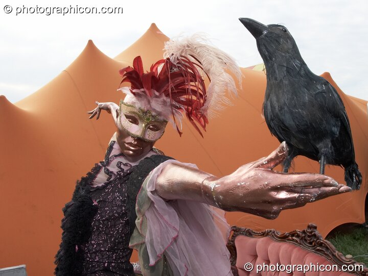 A crow perched on a dress mannequin outside the Prangsta costumiers stall at Sunrise Celebration 2007. Yeovil, Great Britain. © 2007 Photographicon