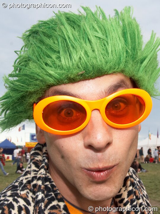 A man dressed to smile in lumo glasses and a green wig at Sunrise Celebration 2007. Yeovil, Great Britain. © 2007 Photographicon
