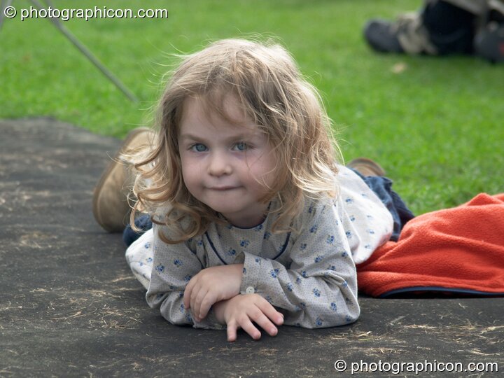A young girl watches a concert by Sing For Water at the Thames Festival 2004. London, Great Britain. © 2004 Photographicon