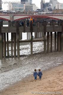 Two small boys play at a Reclaim The Beach party on the sandy river bank at the Thames Festival 2004. London, Great Britain. © 2004 Photographicon