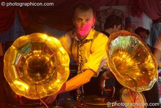 A man DJ's using a pair of wind-up 78 rpm gramophones in the Lost Vagueness tent at the Thames Festival 2004. London, Great Britain. © 2004 Photographicon