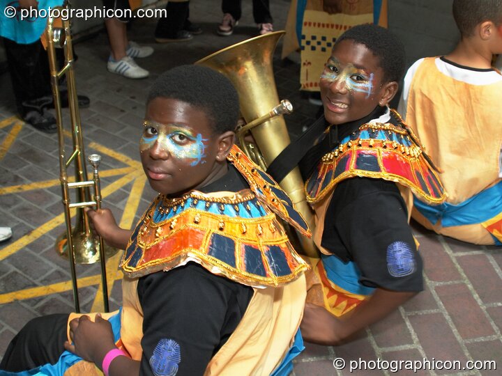 Two boys wearing ancient Egyptian dress prepare for their performance with Kinetika at the Thames Festival 2004. London, Great Britain. © 2004 Photographicon