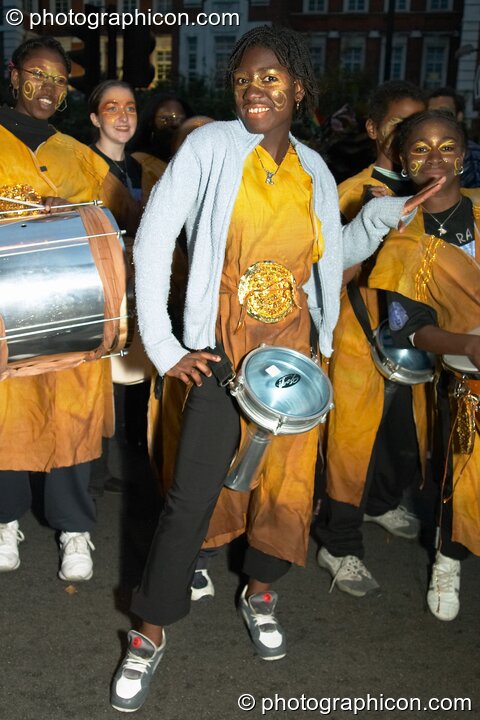 Group of female African drummers pose in the night carnival at the Thames Festival 2004. London, Great Britain. © 2004 Photographicon