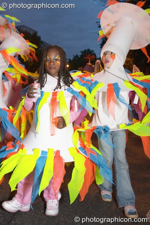 Two girls in costume perform in the night carnival at the Thames Festival 2004. London, Great Britain. © 2004 Photographicon