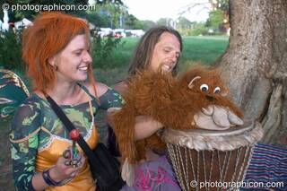A couple play a drum with a hand puppet at the Turaya Gathering 2004. Wimborne, Great Britain. © 2004 Photographicon