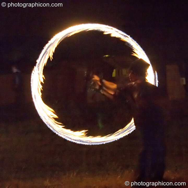 Fire sticks photographed at slow shutter speed to produce motion trails at the Turaya Gathering 2004. Wimborne, Great Britain. © 2004 Photographicon