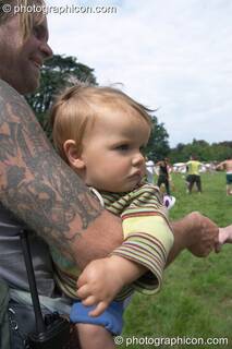 Man holds baby in the Day Out Of Time ritual at the Turaya Gathering 2004. Wimborne, Great Britain. © 2004 Photographicon