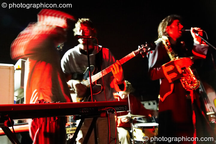 A band performs under night time arc lamps outside the crew cafe at Waveform Project 2007. Kenton, Exeter, Great Britain. © 2007 Photographicon