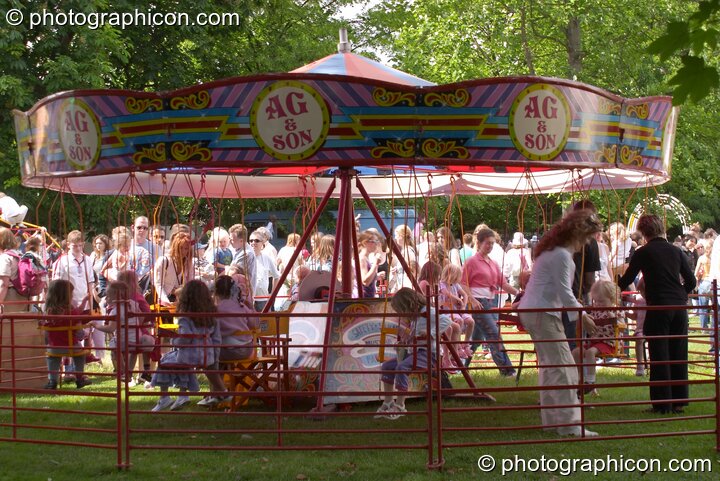 Hand powered merry-go-round at Kingston Green Fair 2004. Kingston Upon Thames, Great Britain. © 2004 Photographicon
