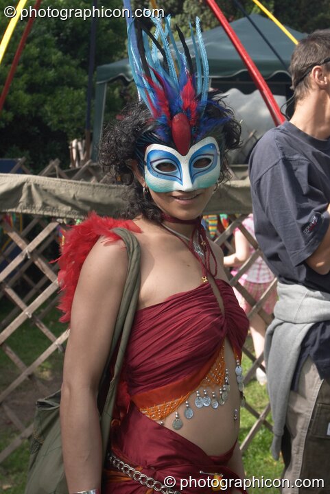 Woman wearing a masquerade face mask at Kingston Green Fair 2004. Kingston Upon Thames, Great Britain. © 2004 Photographicon