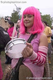 Woman with a pink wig plays a tamberine with Rhythms of Resistance at Kingston Green Fair 2004. Kingston Upon Thames, Great Britain. © 2004 Photographicon