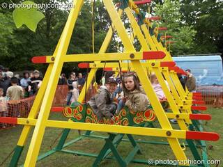 Kids play on the swing boats at Kingston Green Fair 2006. Kingston upon Thames, Great Britain. © 2006 Photographicon