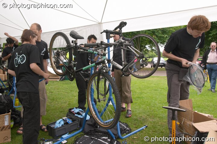 Bike Doctor providing a free bicycle inspection service at the London Green Lifestyle Show 2005. Great Britain. © 2005 Photographicon