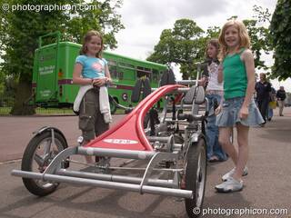 Children ride unusual pedal powered racing carts at the London Green Lifestyle Show 2005. Great Britain. © 2005 Photographicon