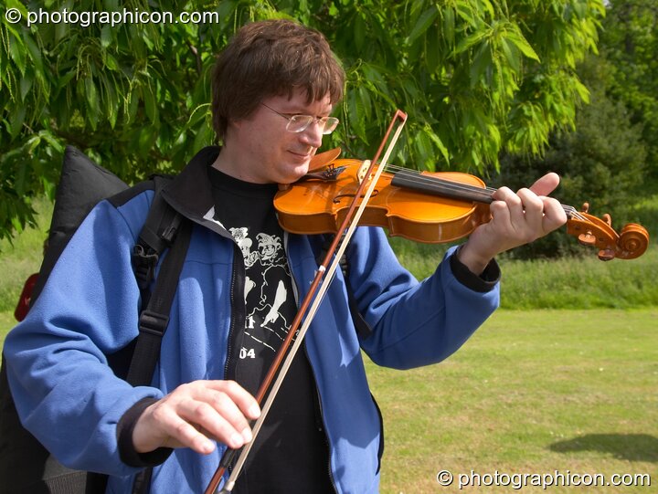 A man plays a violin provided by Surrey Strings at the London Green Lifestyle Show 2005. Great Britain. © 2005 Photographicon