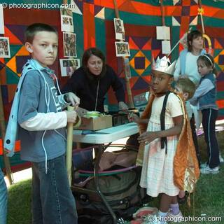Two boys prepare their fancy dress in the Save The World Club carnival workshop at the London Green Lifestyle Show 2005. Great Britain. © 2005 Photographicon