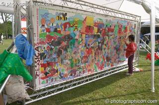 A child uses the painting wall at the London Green Lifestyle Show 2005. Great Britain. © 2005 Photographicon