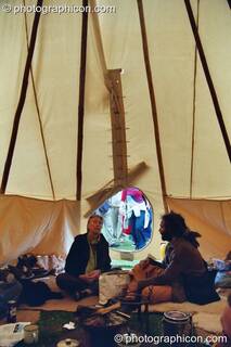 A shot from inside a wigwam of two men sitting in conversation at Kingston Green Fair 2002. Kingston upon Thames, Great Britain. © 2002 Photographicon