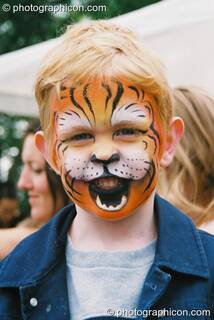 Boy with his face professionally painted as a lion at Kingston Green Fair 2003. Kingston upon Thames, Great Britain. © 2003 Photographicon