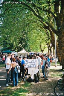 A stall in a long avenue of trees by the River Thames at Kingston Green Fair 2003. Kingston upon Thames, Great Britain. © 2003 Photographicon