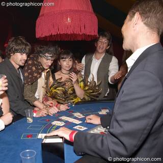 Man wins his hand on the casino card table at the Lost Vagueness Summer Party 2004. Lewes, Great Britain. © 2004 Photographicon