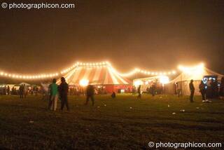 Long strings of fairy lights strung across the marquees glow in the night mist at the Lost Vagueness Summer Party 2004. Lewes, Great Britain. © 2004 Photographicon