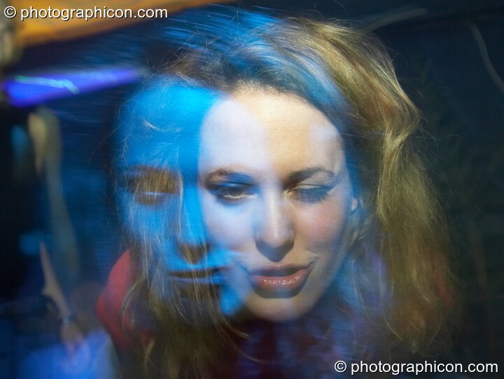 A double face exposure created by the female subject moving under blue light during a long exposure frozen by camera flash. London, Great Britain. © 2006 Photographicon