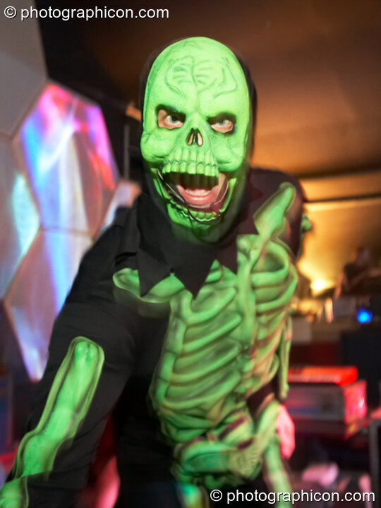 Tristan Cooke performing on the main stage in a luminous skeleton costume at the Twisted Records 10th Birthday Party. London, Great Britain. © 2006 Photographicon