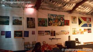 Paintings hanging on the wall in the chillout at Saharawi, The Synergy Centre. London, Great Britain. © 2007 Photographicon
