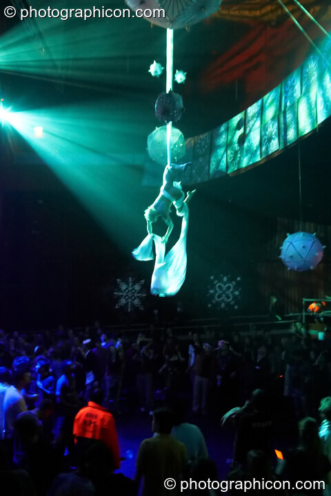 A woman from Fluorotrash performs acrobatics while hanging from silk above the main room at the Pukka / Interpole / Mindscapes Halloween party. London, Great Britain. © 2007 Photographicon