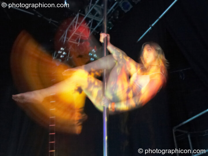 Fluorotrash Ingrid pole dances on the main stage lit by projection from Coldcut at the Pukka / Interpole / Mindscapes Halloween party. London, Great Britain. © 2007 Photographicon