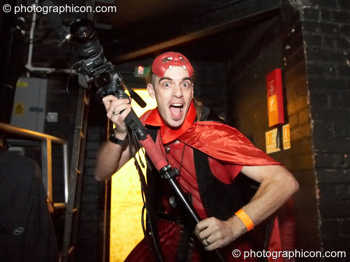 Bruce clutches his camera while wearing a devil costume at the Pukka / Interpole / Mindscapes Halloween party. London, Great Britain. © 2007 Photographicon